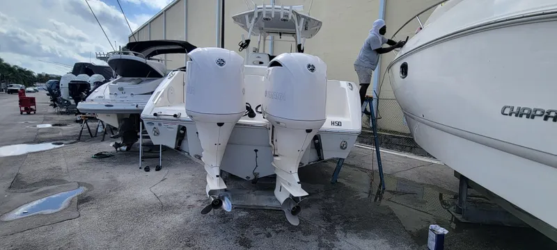  Yacht Photos Pics 2020 Cobia 320 Center Console boat with dual engines in a marina setting.