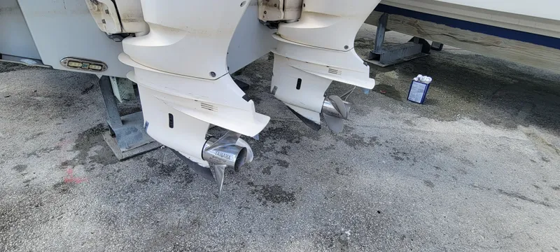 Yacht Photos Pics 2020 Cobia 320 Center Console boat engines on a concrete surface.