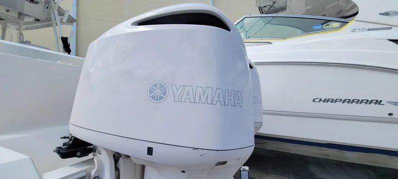  Yacht Photos Pics 2020 Cobia 320 Center Console with Yamaha outboard engine, docked beside Chaparral boat.