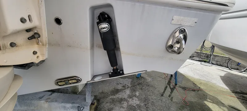  Yacht Photos Pics 2020 Cobia 320 Center Console boat transom with trim tab and hydraulic components.