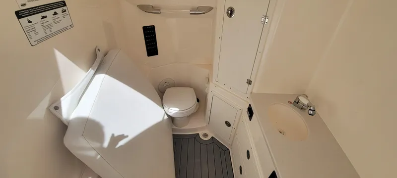  Yacht Photos Pics 2020 Cobia 320 Center Console boat interior with toilet and sink.