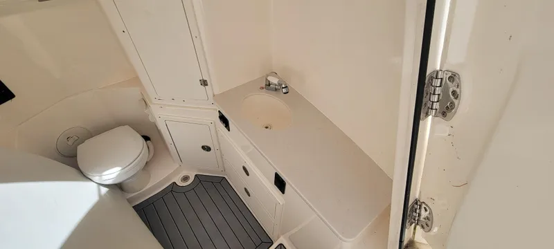  Yacht Photos Pics 2020 Cobia 320 Center Console boat interior with toilet and sink.