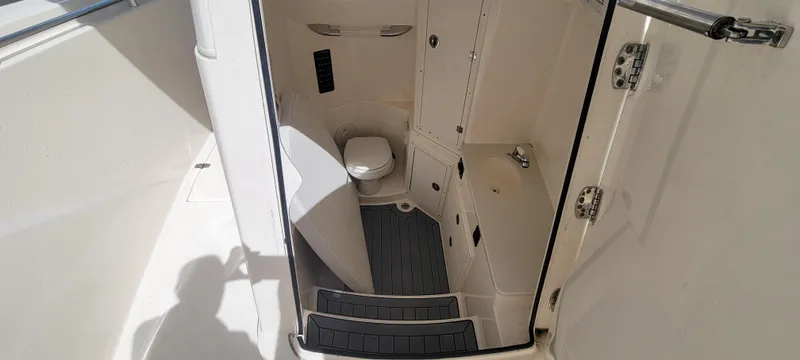  Yacht Photos Pics 2020 Cobia 320 Center Console boat interior with compact bathroom and toilet.