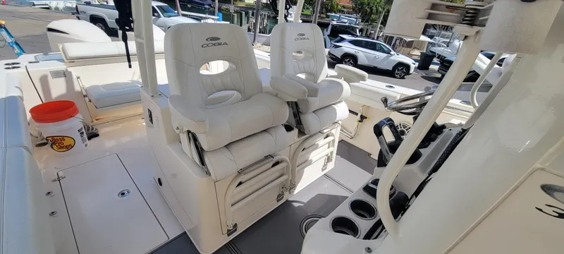  Yacht Photos Pics 2020 Cobia 320 Center Console boat interior with white seating and helm controls.