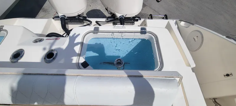 Yacht Photos Pics 2020 Cobia 320 Center Console livewell with water, fishing rod holders, and engine controls.