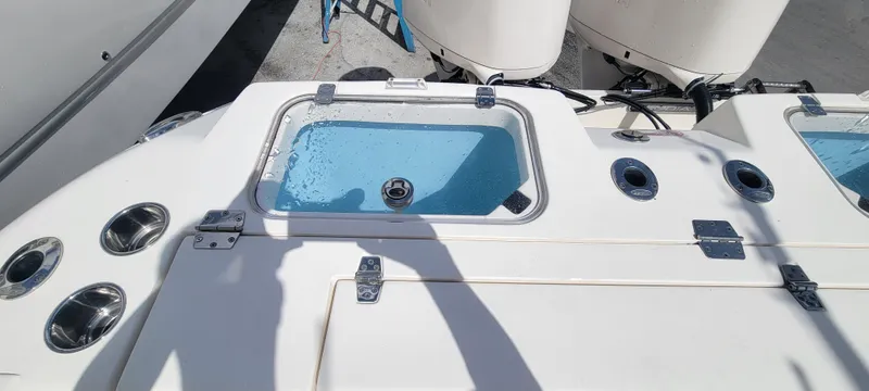  Yacht Photos Pics 2020 Cobia 320 Center Console boat deck with livewell and rod holders.