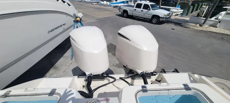  Yacht Photos Pics 2020 Cobia 320 Center Console with dual outboard engines at a marina.