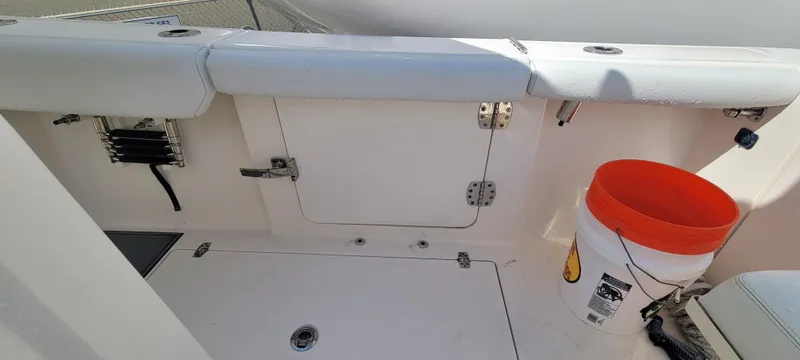 Yacht Photos Pics 2020 Cobia 320 Center Console boat interior with storage compartment and orange bucket.