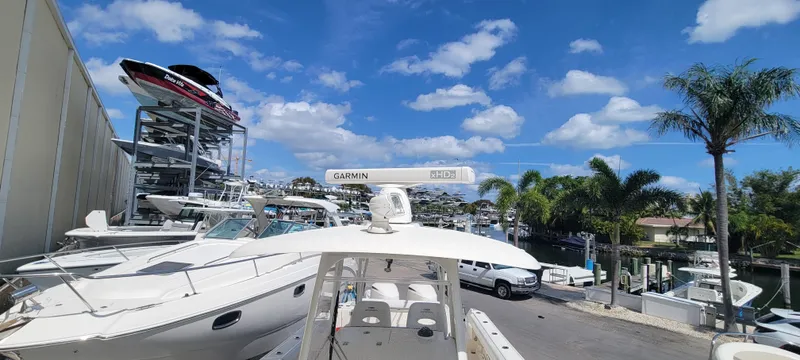  Yacht Photos Pics 2020 Cobia 320 Center Console boat docked under a clear blue sky.