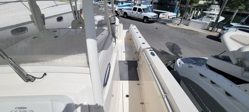  Yacht Photos Pics 2020 Cobia 320 Center Console boat docked at marina, side view.