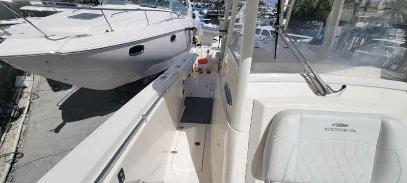  Yacht Photos Pics 2020 Cobia 320 Center Console boat docked, showcasing sleek design and spacious deck.