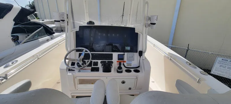  Yacht Photos Pics 2020 Cobia 320 Center Console boat dashboard with steering wheel and controls.
