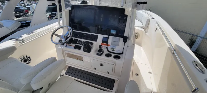  Yacht Photos Pics 2020 Cobia 320 Center Console boat interior with steering wheel and control panel.