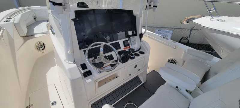 Yacht Photos Pics 2020 Cobia 320 Center Console boat interior with steering wheel and control panel.