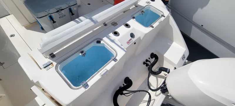  Yacht Photos Pics 2020 Cobia 320 Center Console boat with dual livewells and outboard motor.