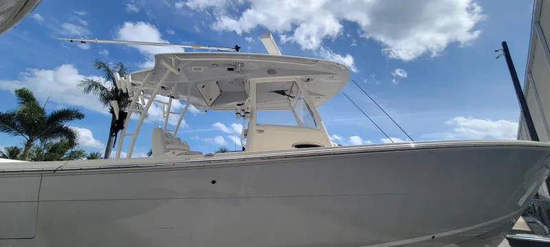  Yacht Photos Pics 2020 Cobia 320 Center Console boat under a clear blue sky.