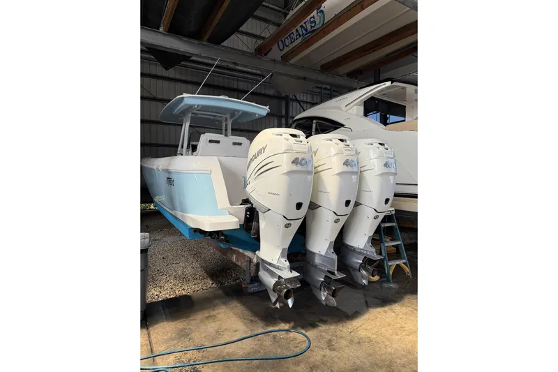 Solete 3 Yacht Photos Pics 2020 Intrepid 375 Nomad FE boat with triple Mercury 400 engines in a storage facility.
