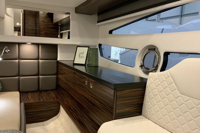 Custom Order Your 33 Ht Today! Yacht Photos Pics Luxurious interior of 2026 Cobrey 33 HT yacht with modern wood finishes and elegant seating.