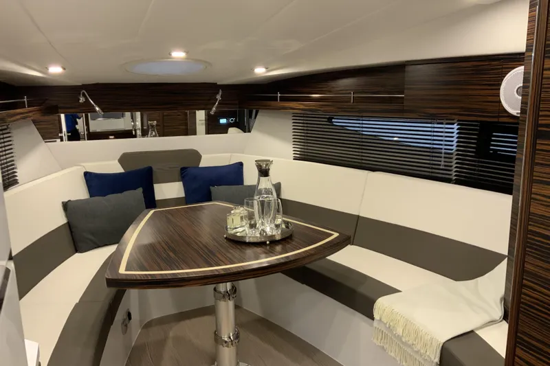Custom Order Your 33 Ht Today! Yacht Photos Pics Luxurious interior of 2026 Cobrey 33 HT yacht with elegant seating and table.