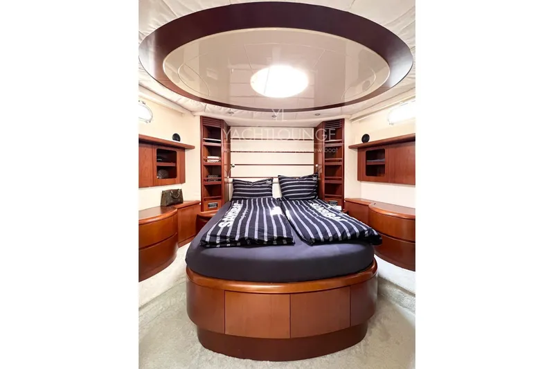  Yacht Photos Pics Luxurious bedroom interior of 2004 Azimut 74 Solar yacht with elegant wood finishes.