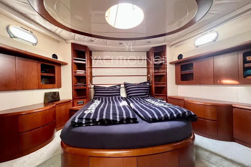  Yacht Photos Pics Luxurious 2004 Azimut 74 Solar yacht bedroom with elegant wood cabinetry and striped bedding.
