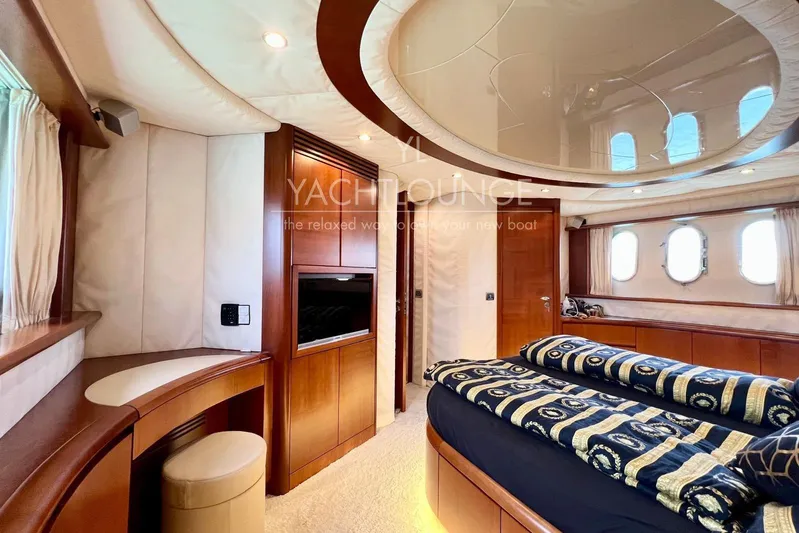  Yacht Photos Pics Luxurious interior of 2004 Azimut 74 Solar yacht with elegant wood finishes and plush bedding.