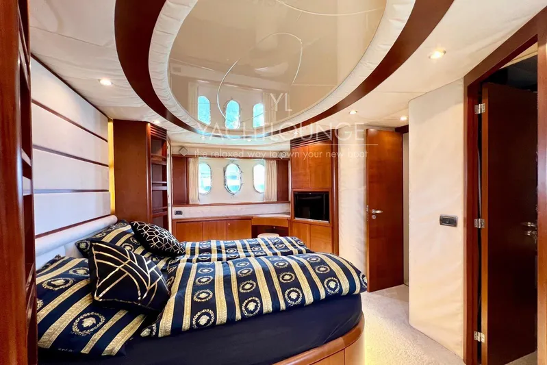  Yacht Photos Pics Luxurious bedroom interior of 2004 Azimut 74 Solar yacht with elegant wood finishes.