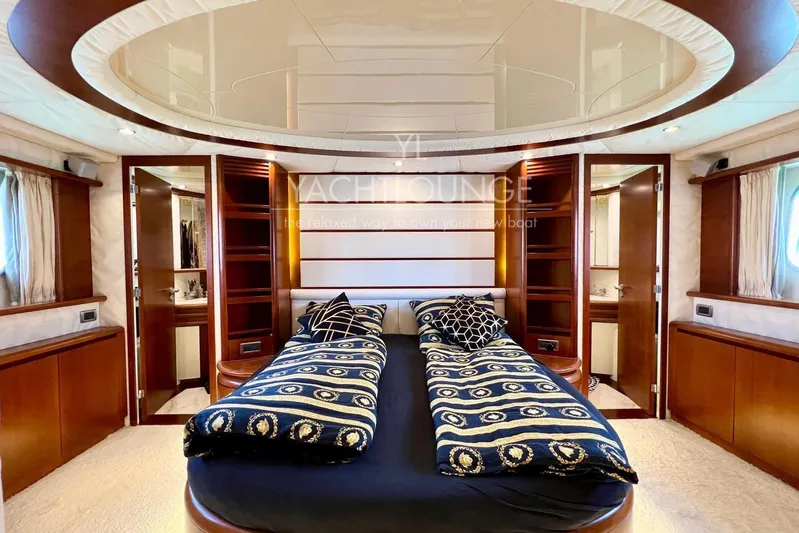  Yacht Photos Pics Luxurious bedroom interior of 2004 Azimut 74 Solar yacht with elegant bedding and wood accents.