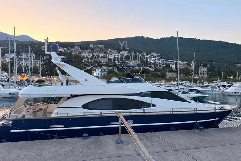  Yacht Photos Pics 2004 Azimut 74 Solar yacht docked at marina during sunset, surrounded by hills and boats.