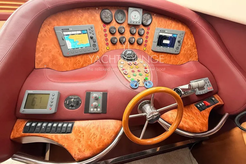  Yacht Photos Pics Luxurious 2004 Azimut 74 Solar yacht helm with advanced navigation controls and wooden steering wheel.