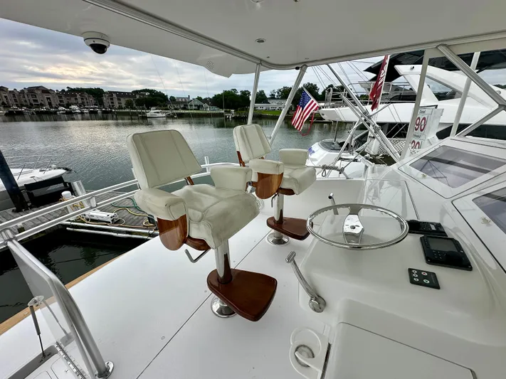 Don't Panic Yacht Photos Pics Viking 56 Convertible SONAR 2004 yacht helm with white captain chairs and marina view.