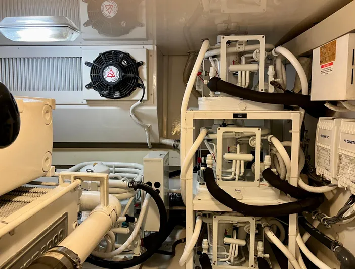 Don't Panic Yacht Photos Pics Engine room of 2004 Viking 56 Convertible SONAR with complex piping and machinery.