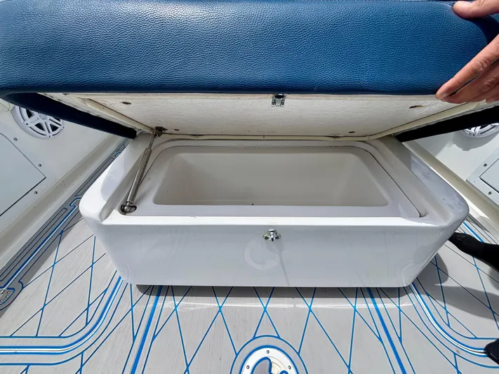  Yacht Photos Pics Open storage compartment on 2007 Midnight Express 39 Cuddy boat with blue cushioned lid.