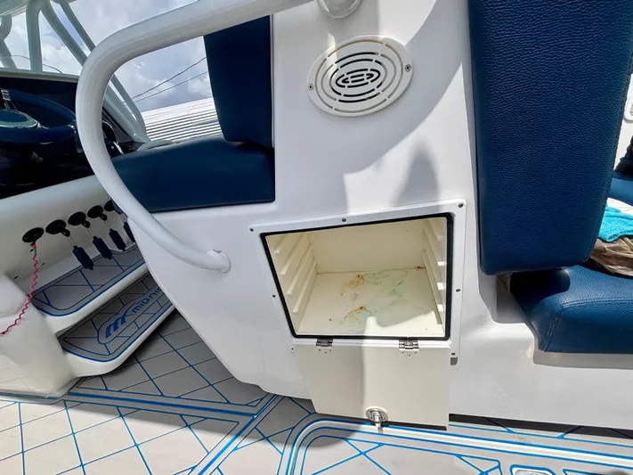  Yacht Photos Pics 2007 Midnight Express 39 Cuddy interior with open storage compartment and blue seating.