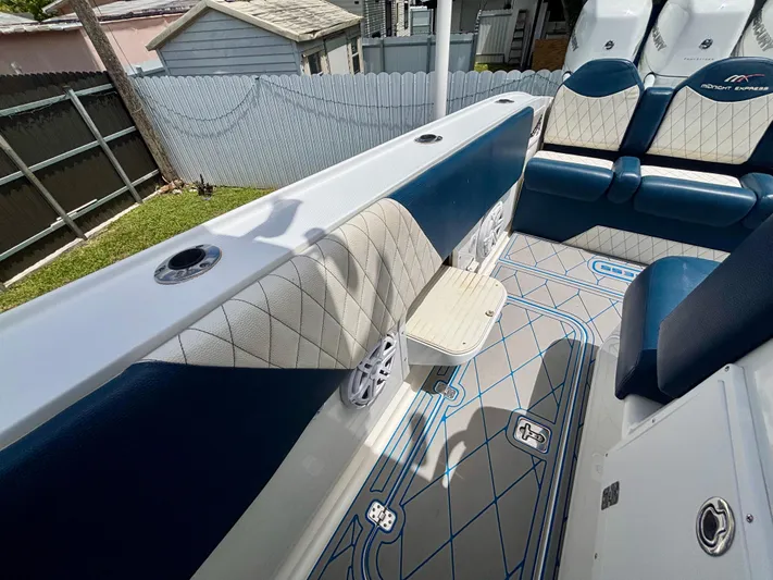  Yacht Photos Pics 2007 Midnight Express 39 Cuddy boat interior with blue and white seating and patterned flooring.