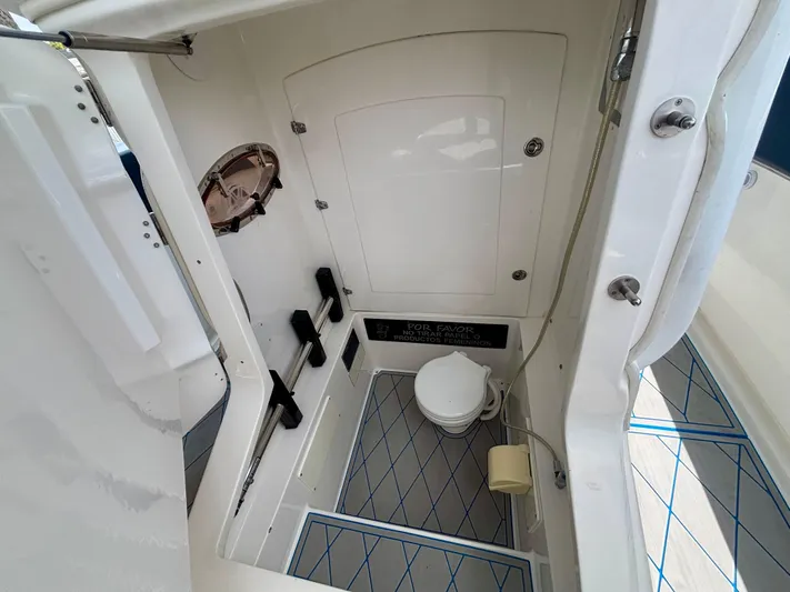  Yacht Photos Pics 2007 Midnight Express 39 Cuddy boat interior with compact bathroom and toilet.