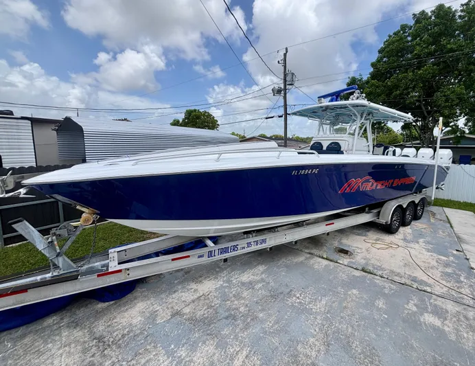  Yacht Photos Pics 2007 Midnight Express 39 Cuddy boat on trailer, blue hull, parked outdoors.