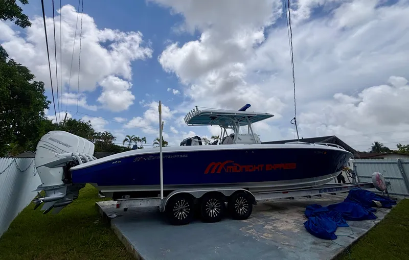  Yacht Photos Pics 2007 Midnight Express 39 Cuddy boat on trailer, parked outdoors under cloudy sky.