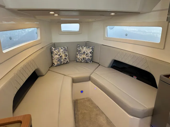 Trouble Maker Yacht Photos Pics Luxurious interior of 2022 Schaefer V33 yacht with plush seating and decorative pillows.