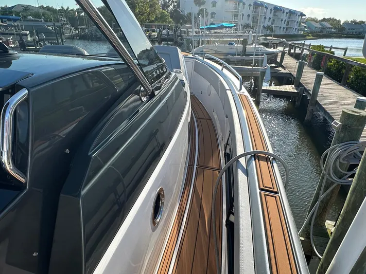 Trouble Maker Yacht Photos Pics Schaefer V33 2022 yacht docked, featuring sleek design and wooden deck details.