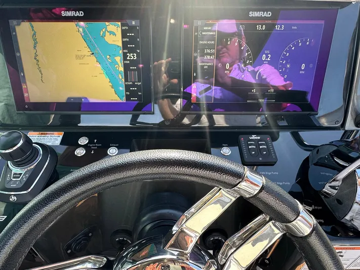 Trouble Maker Yacht Photos Pics Steering wheel and navigation screens on 2022 Schaefer V33 boat dashboard.