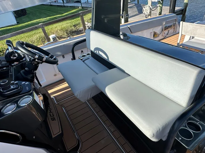 Trouble Maker Yacht Photos Pics 2022 Schaefer V33 boat interior with steering wheel and cushioned seating.