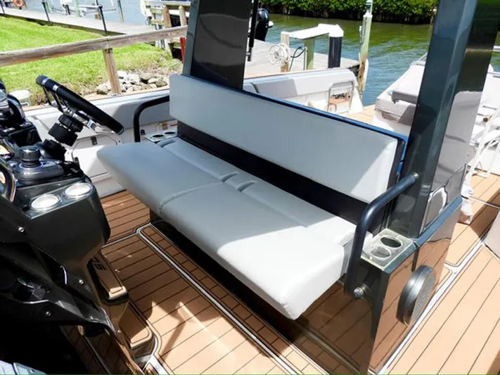 Trouble Maker Yacht Photos Pics 2022 Schaefer V33 boat interior with white seating and wooden deck.