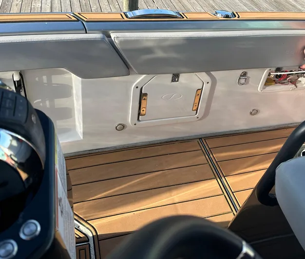 Trouble Maker Yacht Photos Pics Interior view of 2022 Schaefer V33 boat with wooden deck and seating.