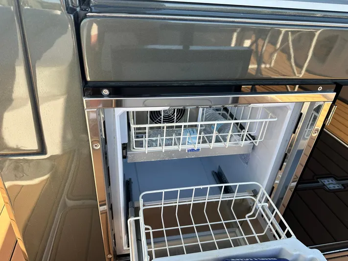 Trouble Maker Yacht Photos Pics Open refrigerator on Schaefer V33 yacht, 2022 model, showcasing interior storage space.