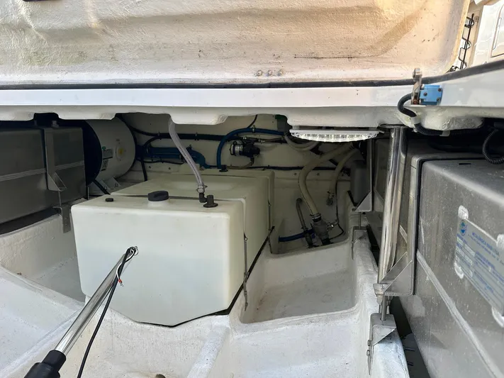 Trouble Maker Yacht Photos Pics Engine compartment of 2022 Schaefer V33 boat, showing storage and mechanical components.