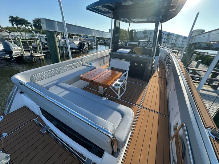 Trouble Maker Yacht Photos Pics 2022 Schaefer V33 boat with sleek deck, seating, and table at marina.