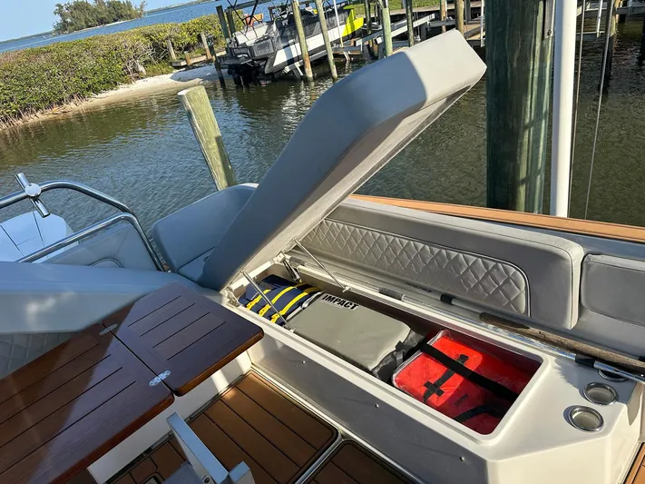 Trouble Maker Yacht Photos Pics 2022 Schaefer V33 boat with open storage compartment, docked by the water.