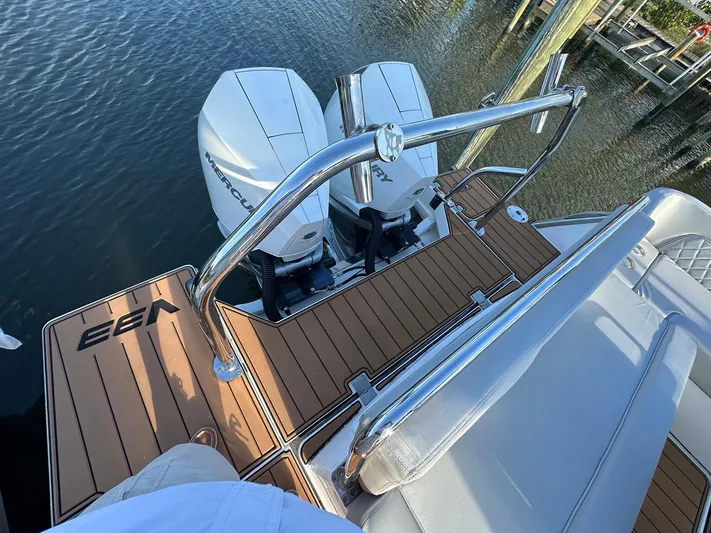 Trouble Maker Yacht Photos Pics 2022 Schaefer V33 boat with twin Mercury engines and teak deck, docked by the water.