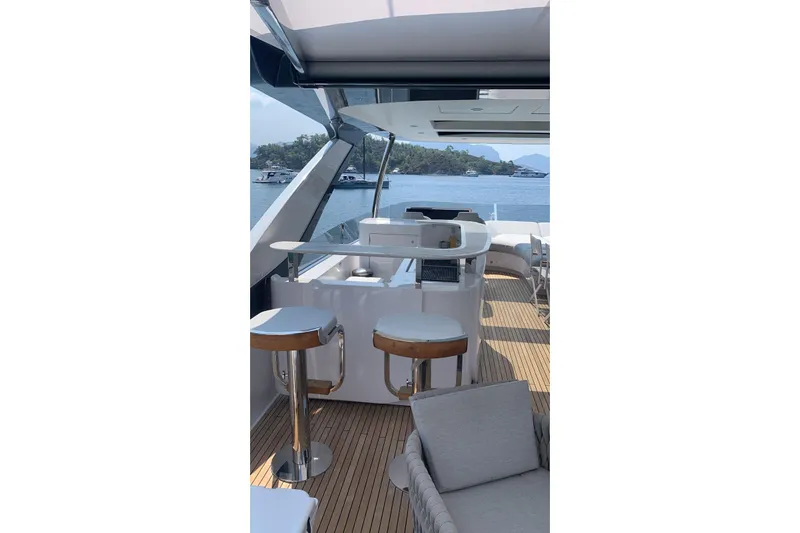 Ma Belle Yacht Photos Pics Luxurious 2022 Azimut Fly 78 yacht deck with bar stools and scenic ocean view.
